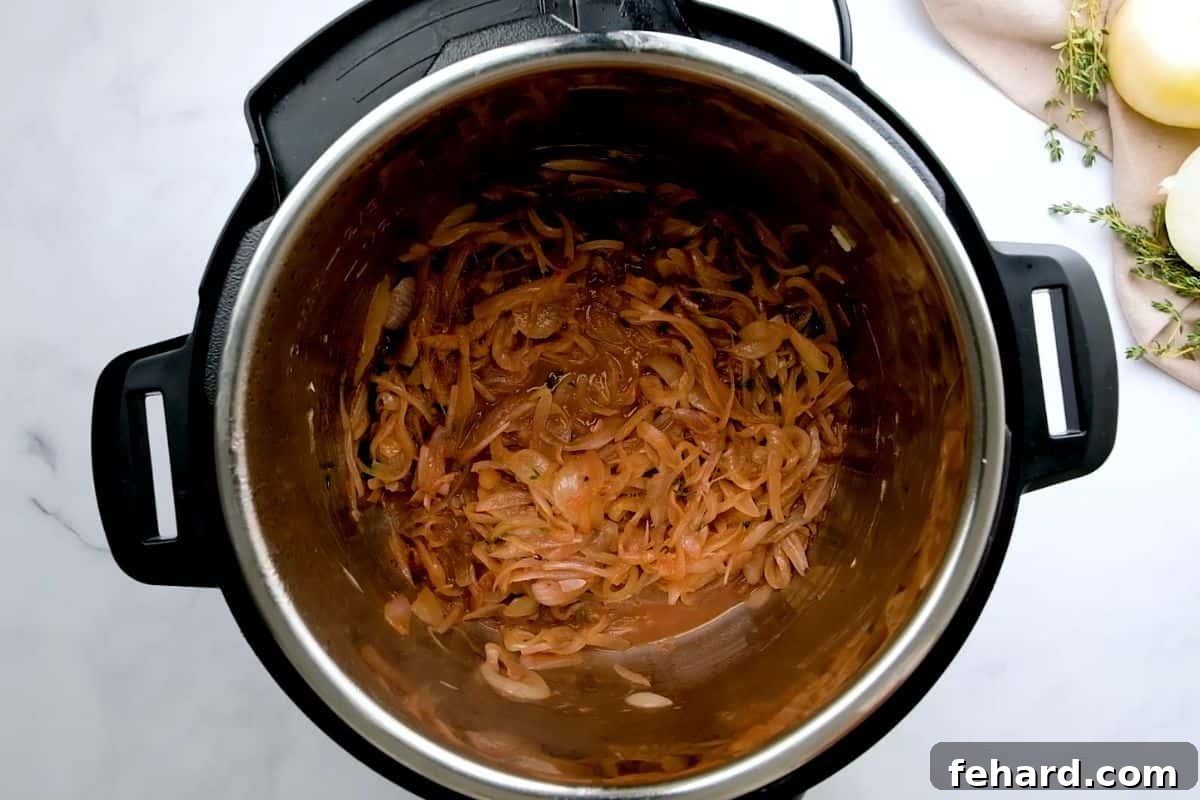 Caramelized onions in the Instant Pot, with red wine added and simmering, as the pot is deglazed to release all the flavorful fond from the bottom.