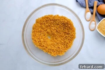 Graham crackers with sugar and butter in mixing bowl.