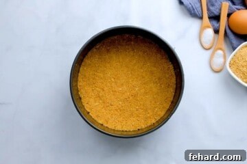 Graham Cracker Crust pressed into a 7-inch springform pan for a classic cheesecake made in instant pot.