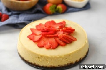 Cheesecake topped with sliced strawberries.