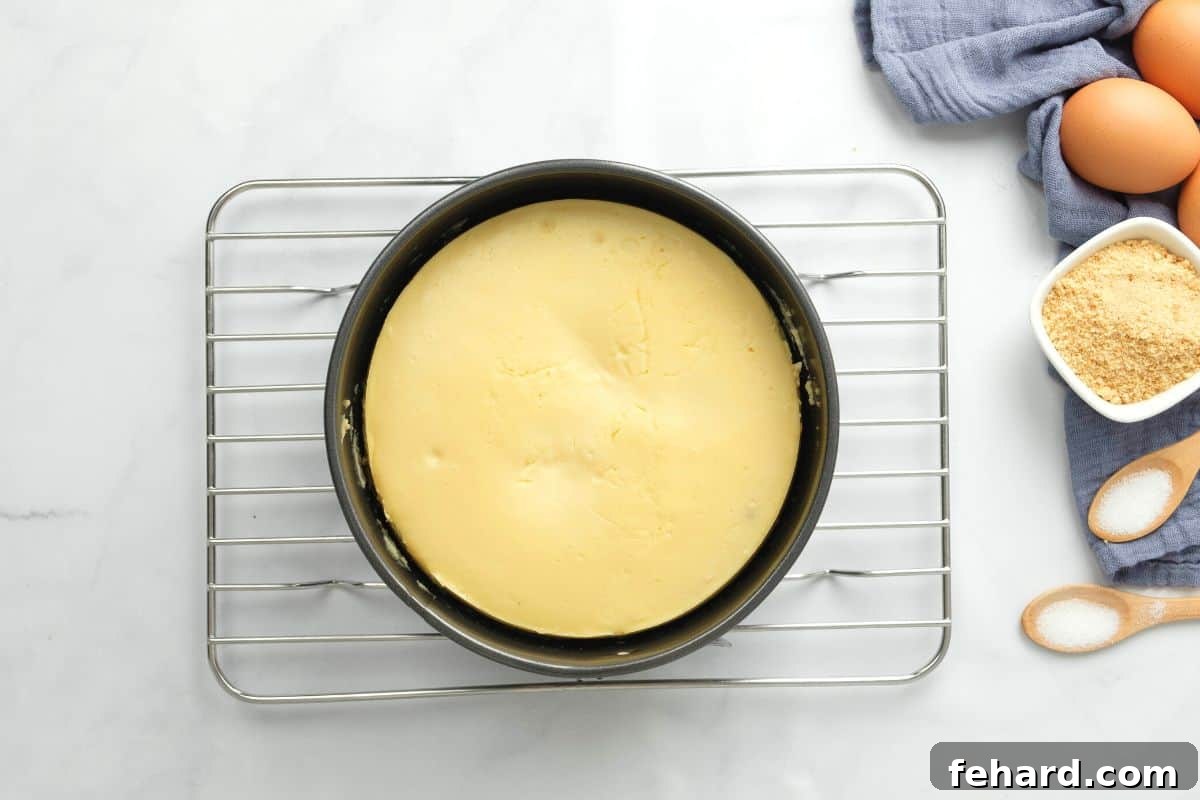 A freshly baked Instant Pot Cheesecake cooling on a wire rack, preparing for its essential chilling phase.