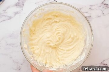Cream cheese filling, perfectly smooth and creamy, in a mixing bowl, ready for spreading.