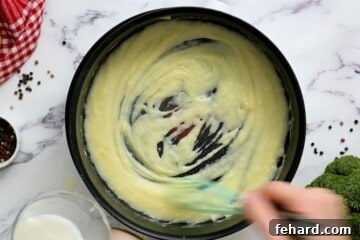 Stock pan with flour and butter being whisked together to form a roux.
