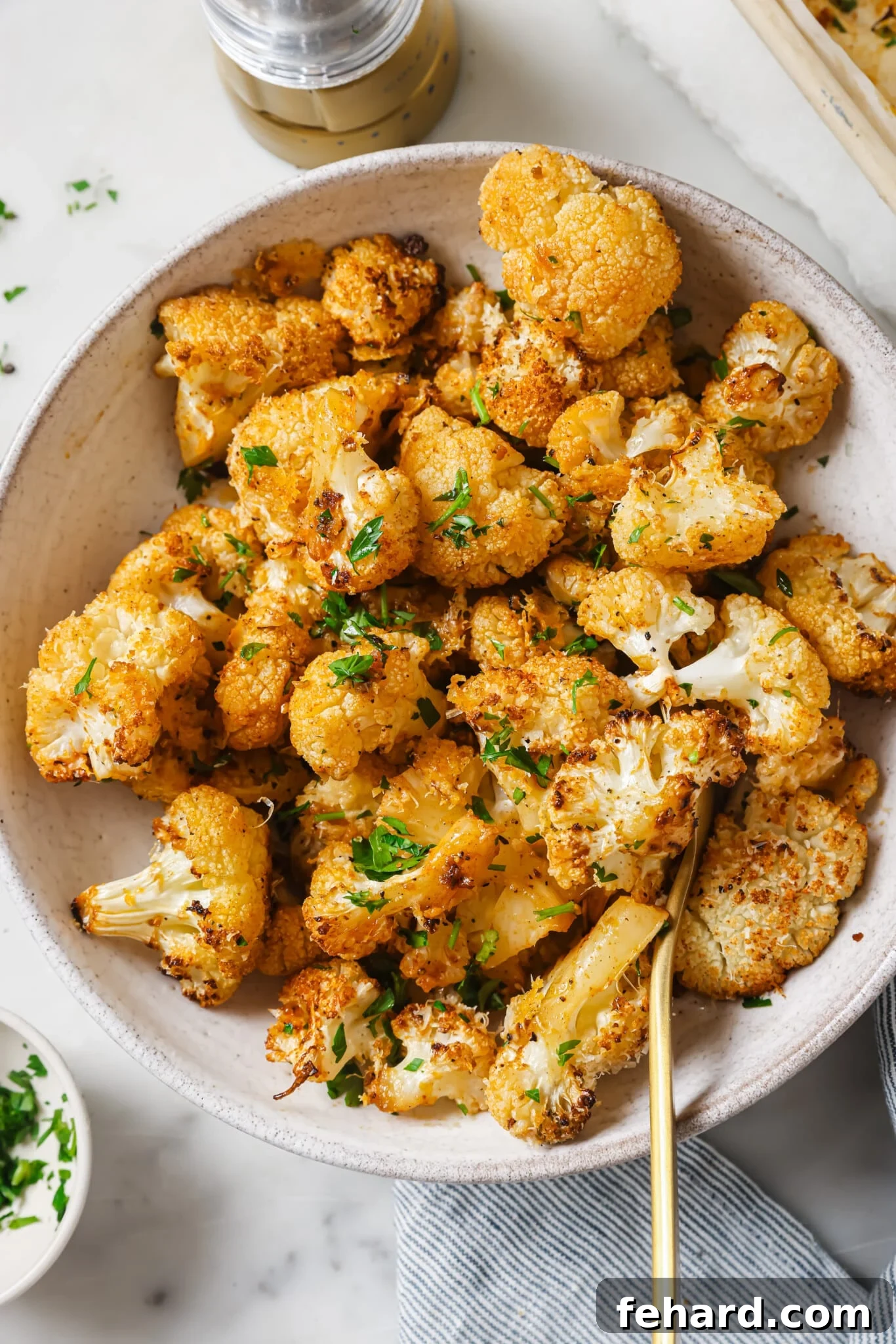 Close up of roasted cauliflower with parsley as garnish. 