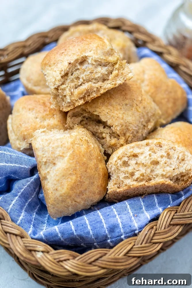 Basket of homemade Whole Wheat Rolls, golden brown and perfectly soft.