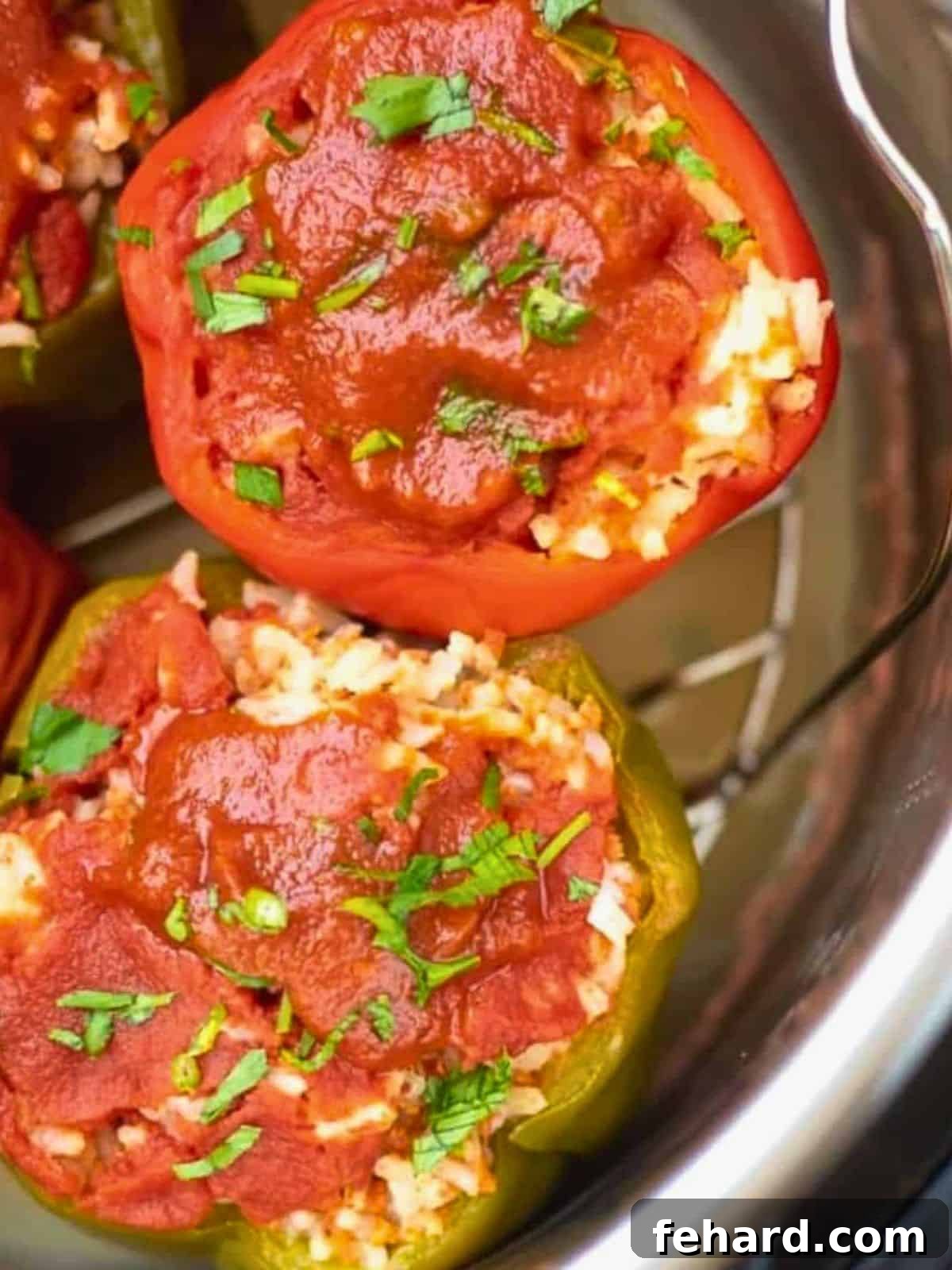 Instant Pot Stuffed Peppers Ready to Serve Four Instant Pot Stuffed Bell Peppers on a trivet, garnished with fresh parsley, nestled inside the Instant Pot after cooking.