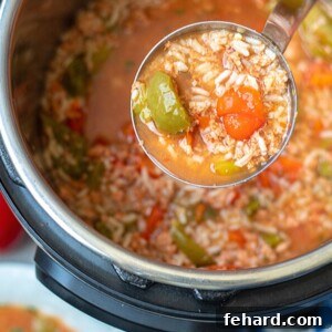 Ladle of Stuffed Peppers Soup coming out of Instant Pot, showcasing its rich texture and ingredients.