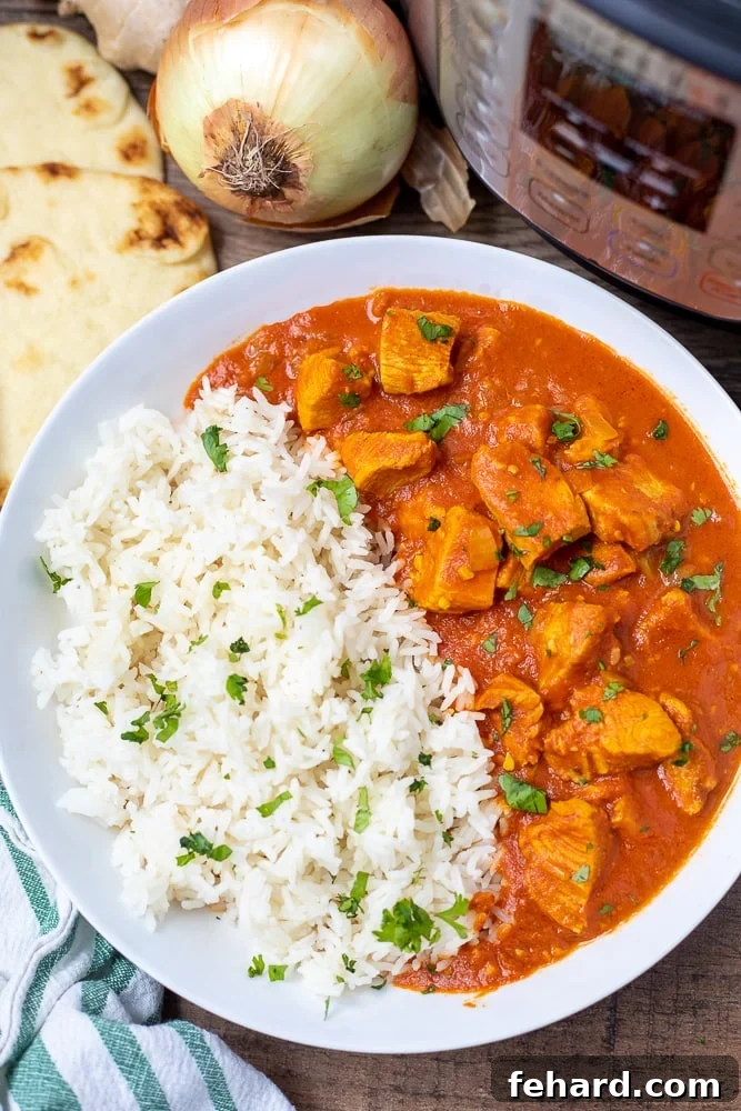 Instant Pot Butter Chicken Bowl of Instant Pot Butter Chicken served with white rice, garnished with fresh cilantro.