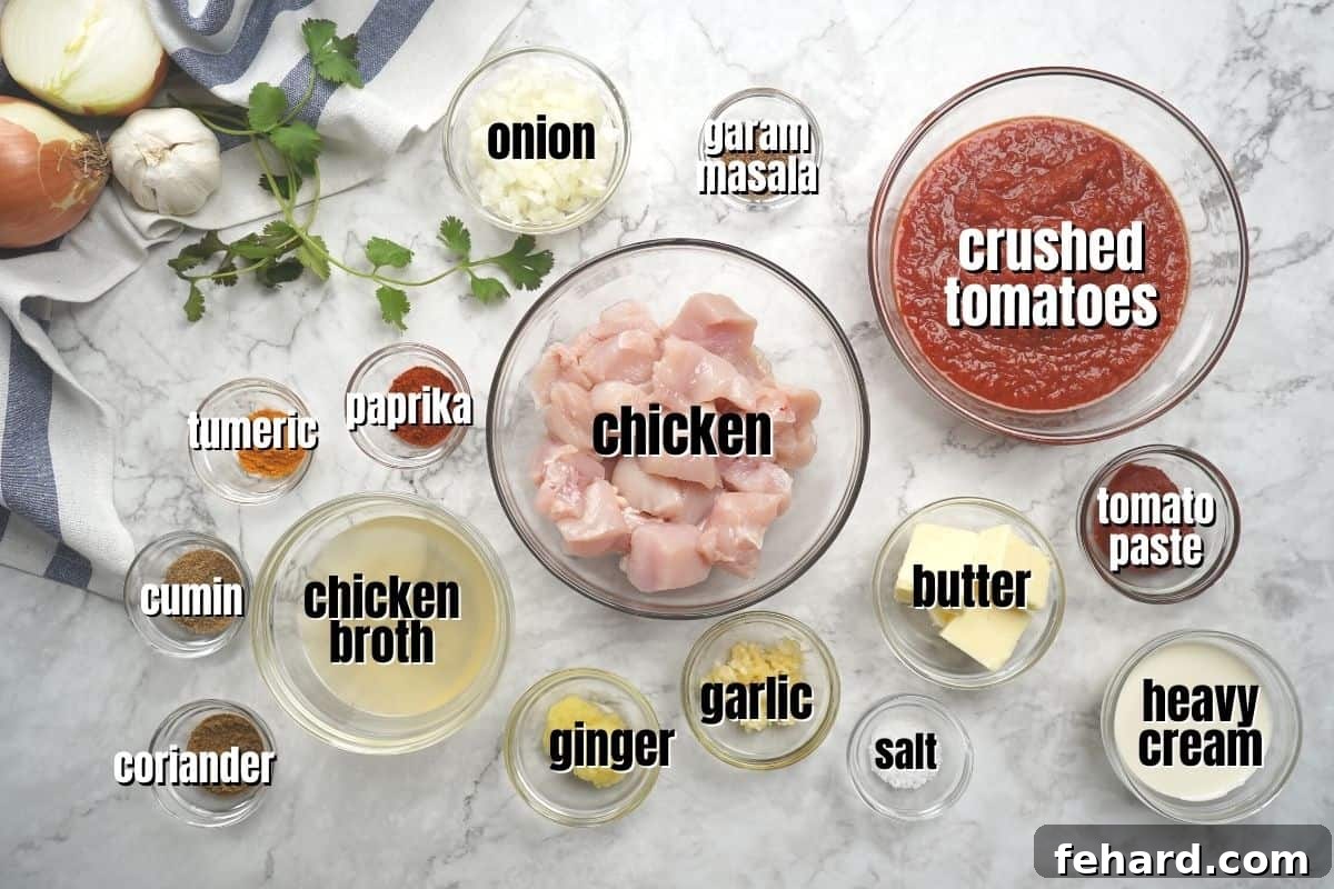 Butter Chicken Instant Pot Collection of ingredients for Butter chicken, including chicken, spices, butter, and tomatoes, neatly arranged on a kitchen counter.