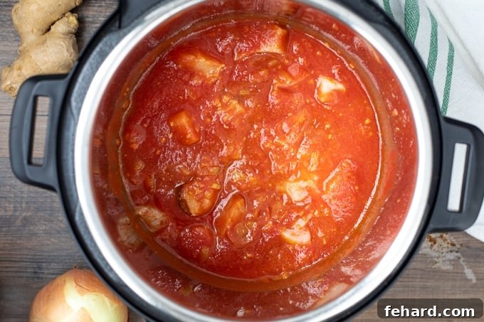 Butter Chicken Recipe for Instant Pot Butter Chicken mixture simmering inside the Instant Pot before the final step.