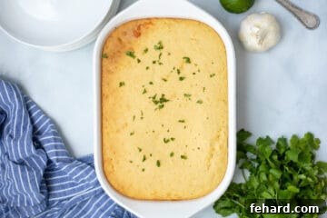 Baked tamale casserole in baking dish topped with minced cilantro.