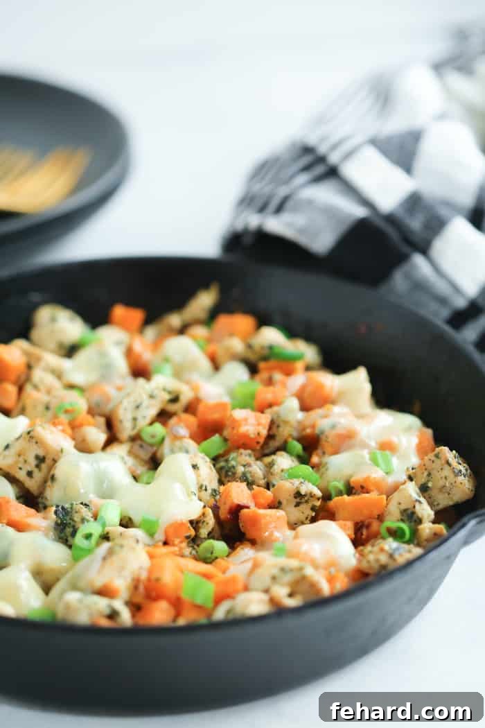 Sweet Potato Chicken Pesto Skillet - A simple, flavorful, and easy-to-clean one-pan meal, perfect for healthy weeknight dinners. close-up of Sweet Potato Chicken Pesto in a cast iron Skillet, emphasizing its golden-brown chicken and tender sweet potatoes