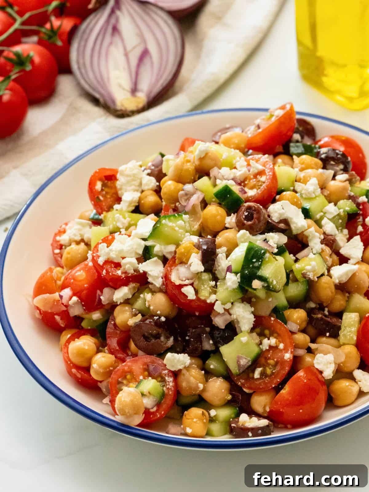 Best Mediterranean Chickpea Salad Recipe A vibrant Mediterranean Chickpea Salad with feta and olives in a beautiful blue bowl, ready to be served.