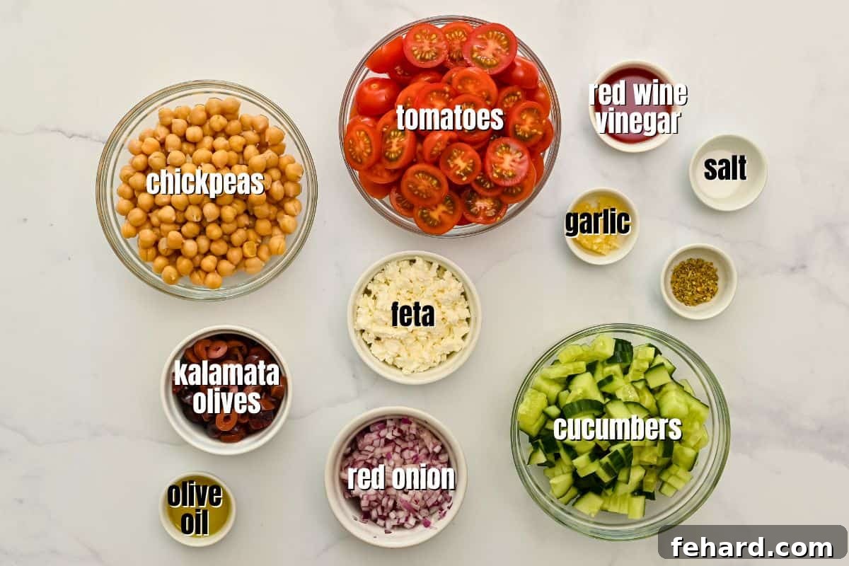 Healthy Chickpea Salad Ingredients Individual bowls holding various fresh ingredients like chickpeas, olives, tomatoes, and cucumber, ready for the Mediterranean Chickpea Salad.