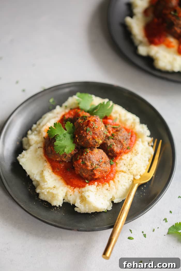 Healthy Turkey Meatballs with Mashed Cauliflower Close-up of baked Turkey Meatballs ready to be served with creamy Mashed Cauliflower