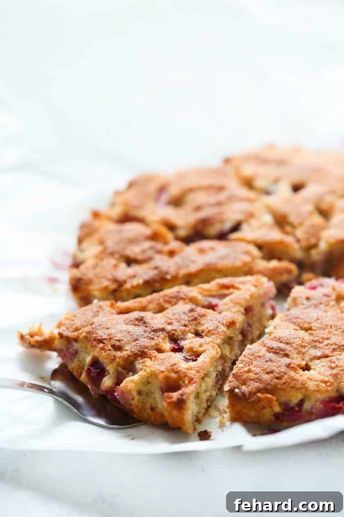 Close-up of a single Strawberry Coconut Scone showing its delicate texture and strawberry pieces, ready to be enjoyed with a cup of tea or coffee.