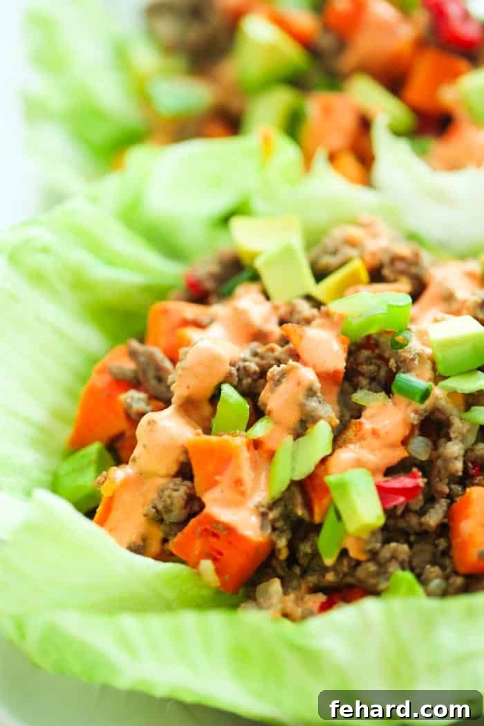 A vibrant display of fresh ingredients, including lettuce, ground turkey, sweet potatoes, and spices, laid out for making healthy wraps.