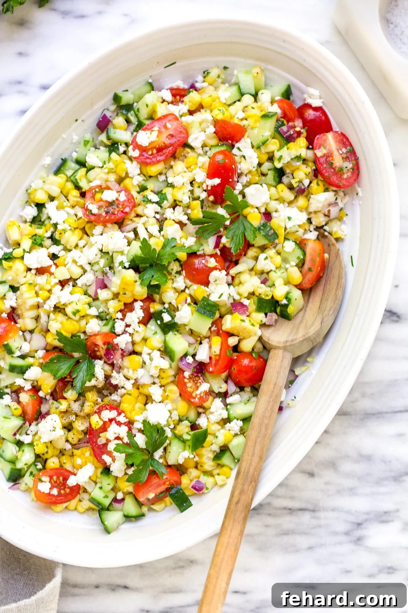 Zesty Corn Salad 6 Overhead view of a beautifully prepared corn salad in a white bowl, garnished with fresh herbs, ready to serve.