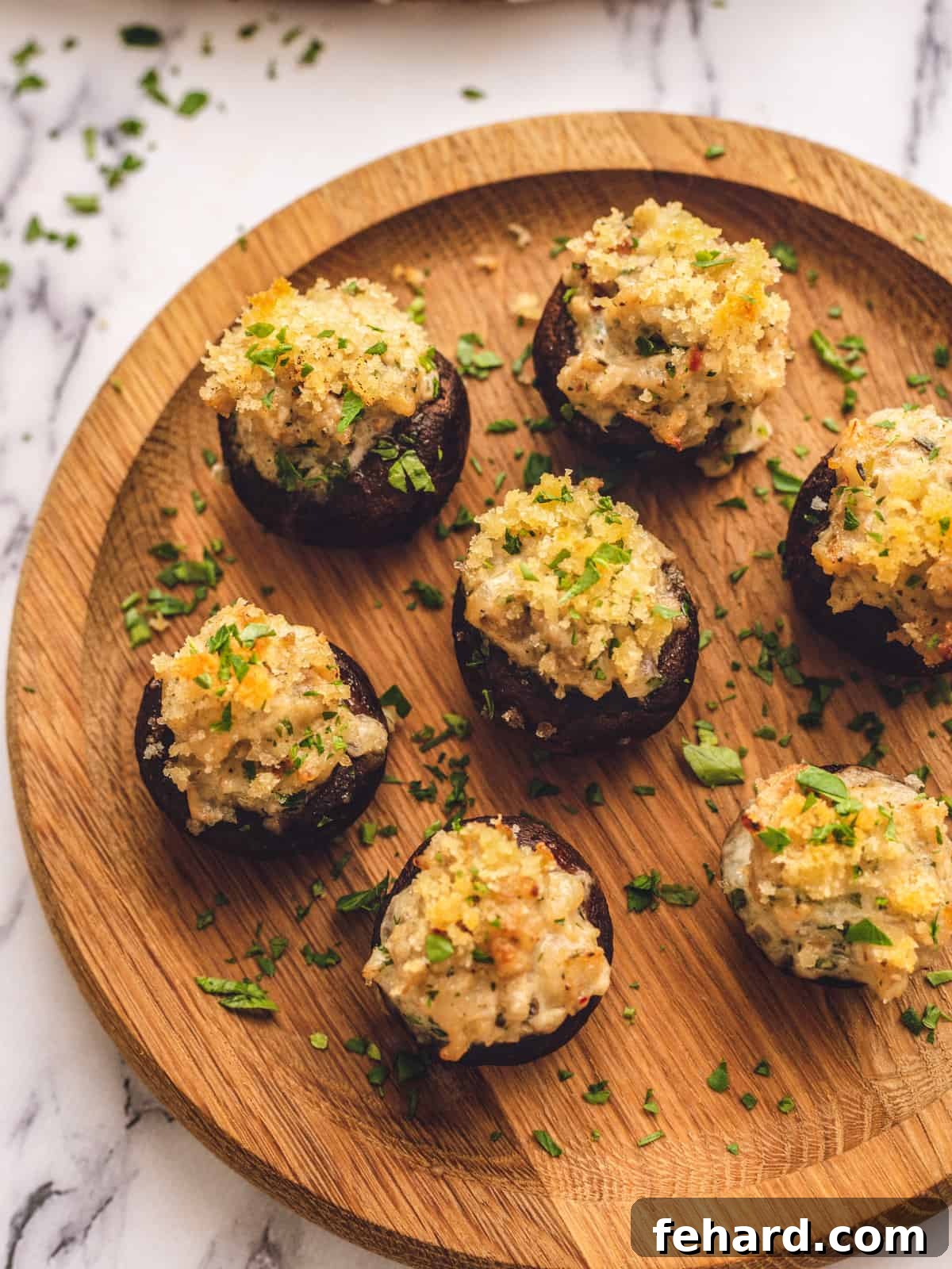 Elegant Sausage Stuffed Mushrooms Appetizer Beautifully arranged sausage stuffed mushrooms with a golden breadcrumb topping on a rustic wooden serving platter, ready for guests.