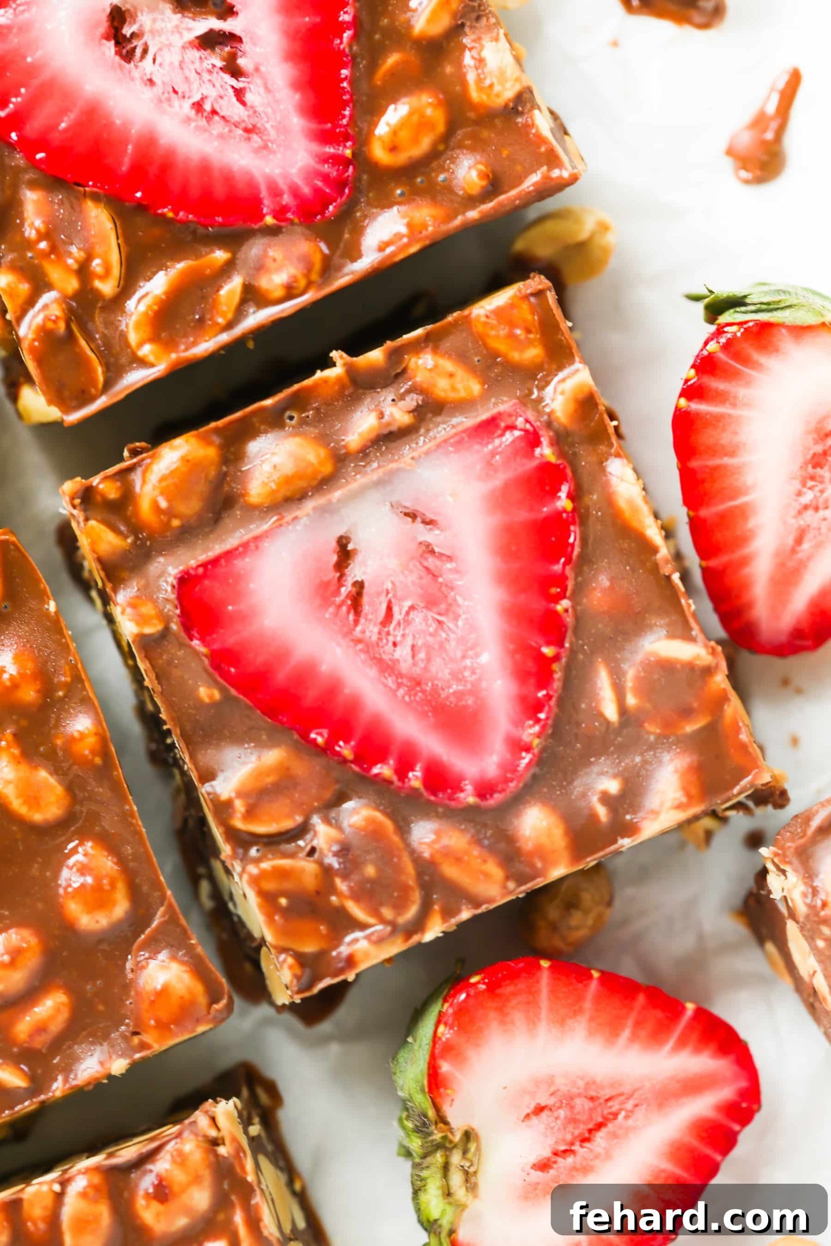 Irresistible Low-Carb No-Bake Chocolate Strawberry Bars Close-up of freshly made no-bake chocolate strawberry bars with visible peanut butter, dark chocolate, and sliced strawberries.