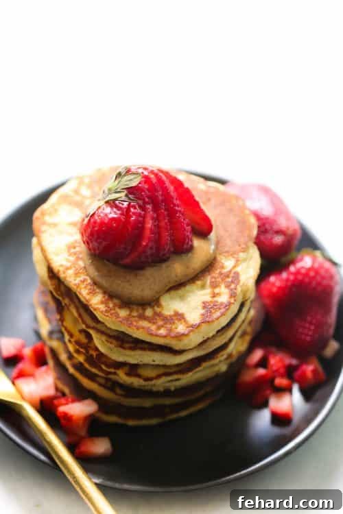 Fluffy 3-Ingredient Almond Flour Banana Pancakes with fresh strawberries