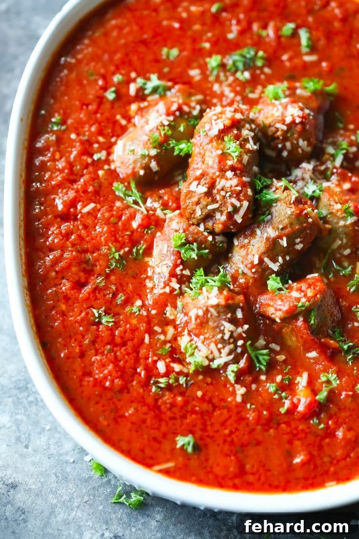 Rich and flavorful Italian Sausage Tomato Sauce simmering in a pot, ready to be served over pasta.