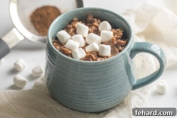Hot Chocolate Oatmeal in blue mug topped with marshmallows.
