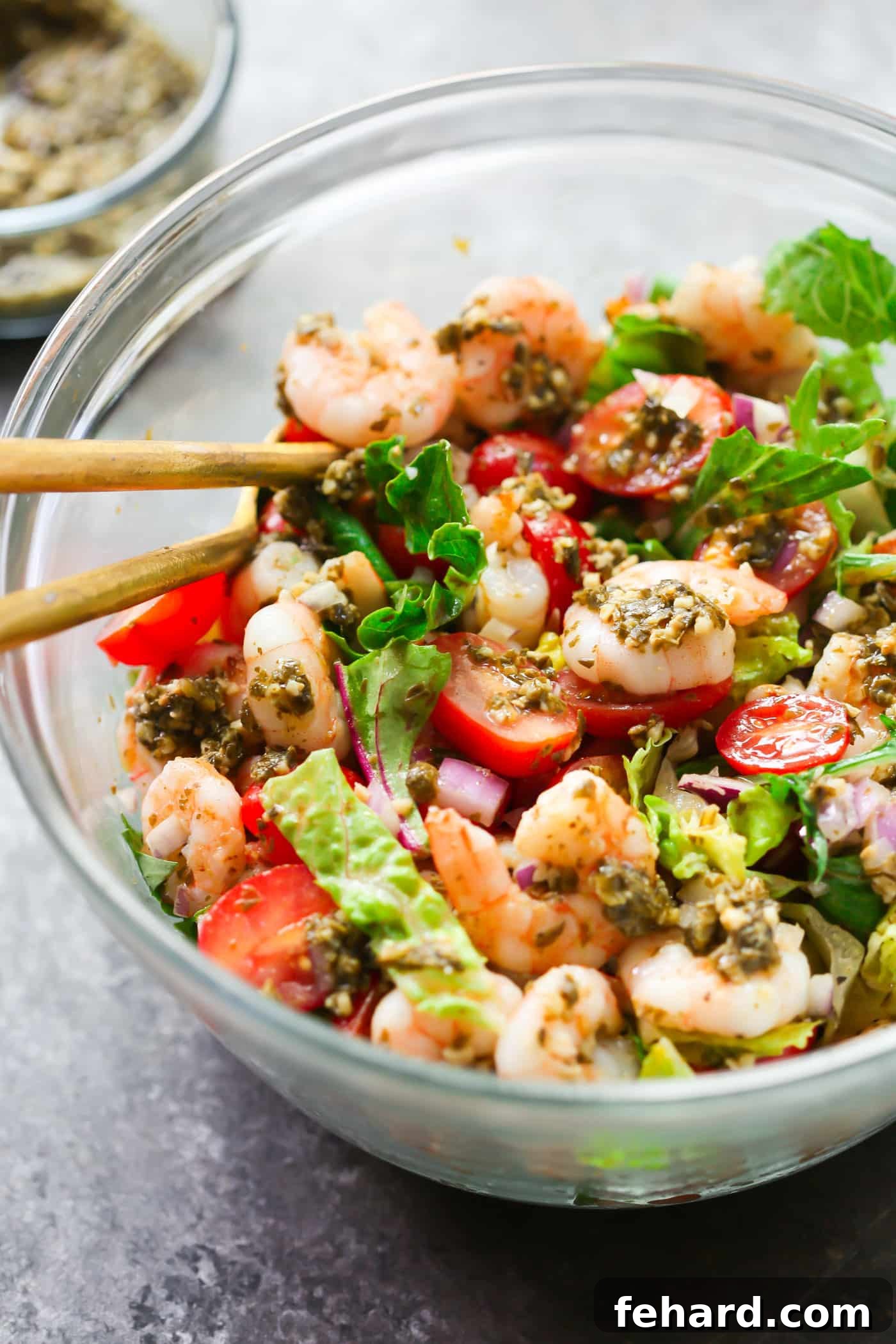 A vibrant Pesto Shrimp Tomato Salad artfully arranged in a large bowl, ready to be served.