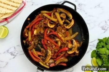 Sauteed Peppers, Onions, and Mushrooms in skillet for Veggie Fajita Recipe.
