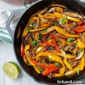Mixture of portobello mushrooms and onions and peppers for Vegetarian fajitas in cast iron skillet.