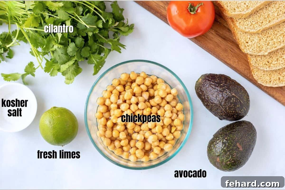 Simple Ingredients for Easy Chickpea Avocado Salad A selection of fresh ingredients for chickpea avocado salad including ripe avocados, canned chickpeas, and vibrant limes on a kitchen counter.