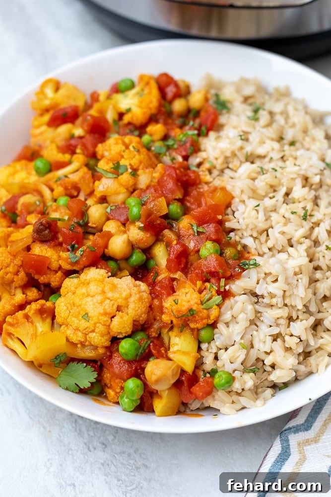Cauliflower Tikka Masala in white dish with brown rice.