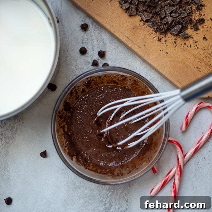 Whisking Cocoa into Milk Cocoa paste being whisked into warm milk in a bowl, creating a smooth mixture.
