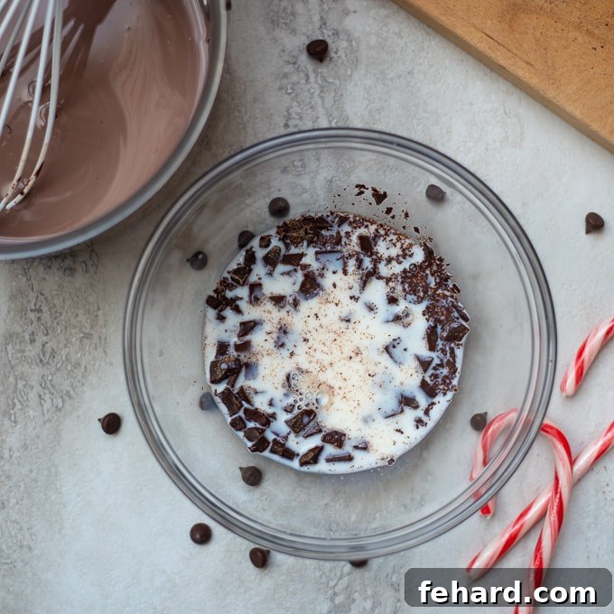 Melting Chocolate for Hot Chocolate Bowl of chocolate chunks with warm milk poured over them, being stirred to melt.