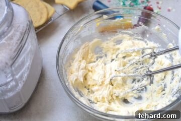 Mixing Bowl with Butter and Cream Cheese Creamed, a crucial step for smooth sugar cookie icing.