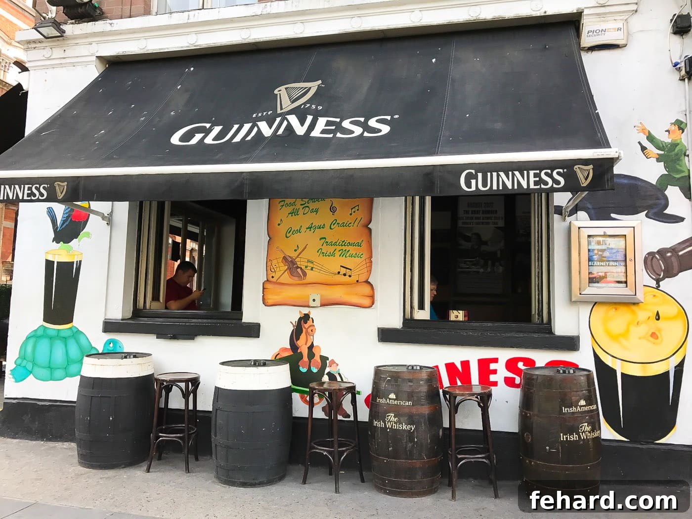An inviting outdoor seating area of a Dublin pub, featuring beer kegs as tables