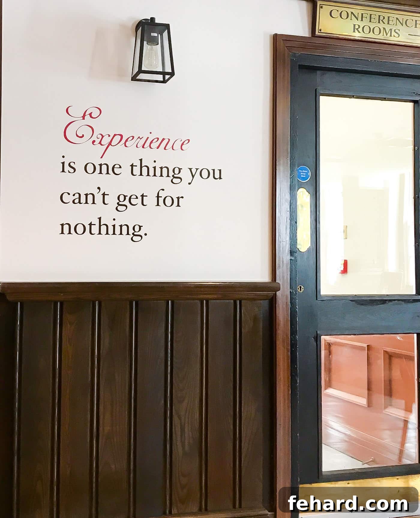 A wall at Oscar's Bar & Kitchen displaying the Oscar Wilde quote: 'Experience is one thing you can't get for nothing.'