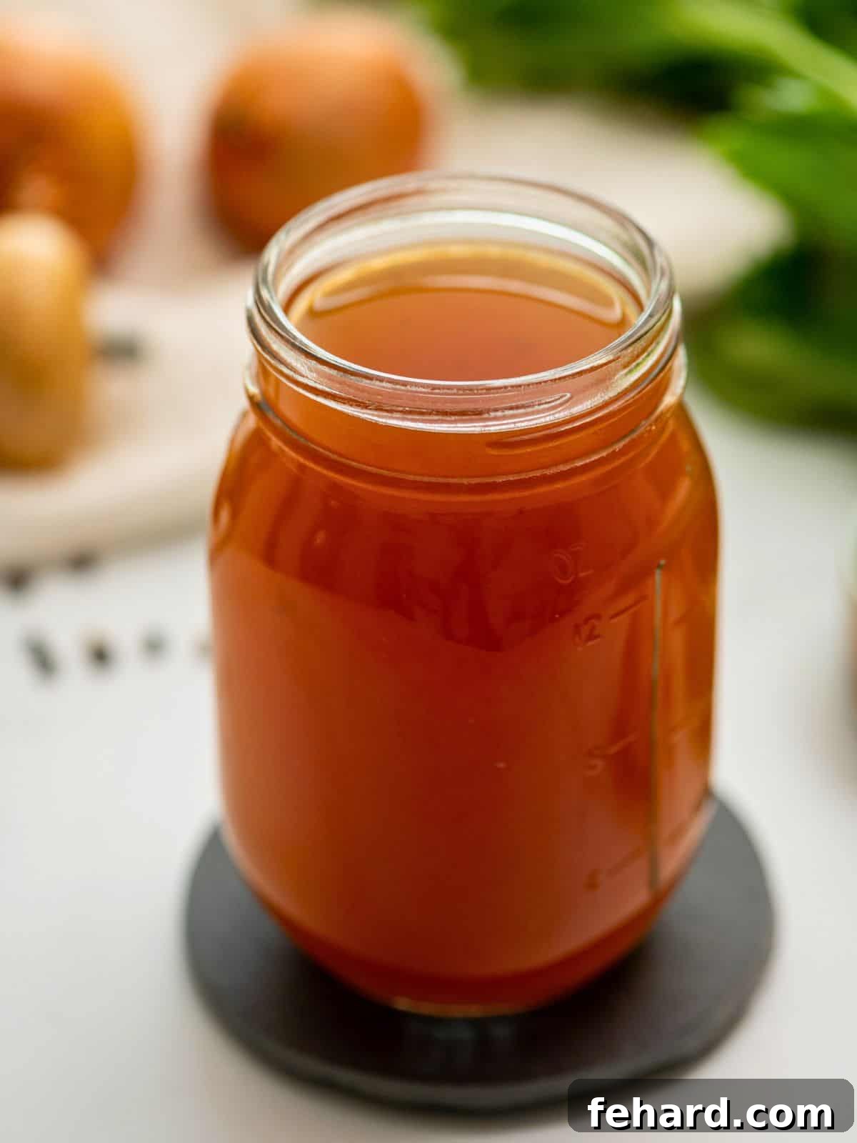 Homemade Vegetable Broth Jar of homemade vegetable broth, showcasing its rich golden color and clarity.