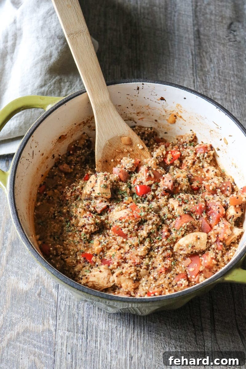Hearty Quinoa Jambalaya served in a rustic Dutch oven with a wooden spoon