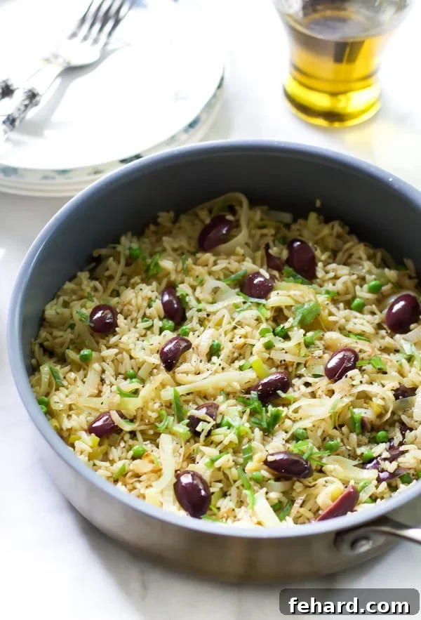 A vibrant bowl of Leek Kalamata Rice, garnished with fresh green onions, inviting you to a delightful dinner experience.