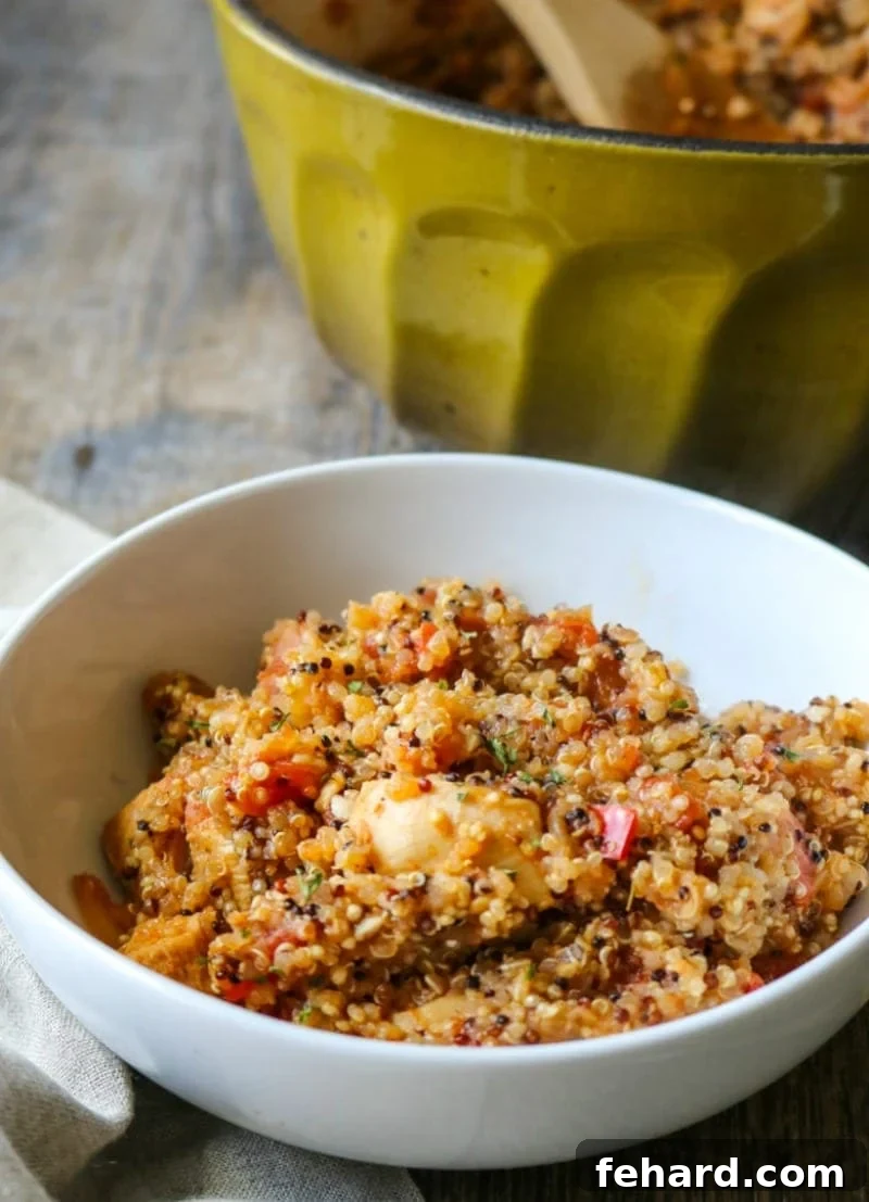 A white bowl brimming with fresh, hot Quinoa Jambalaya, ready to eat
