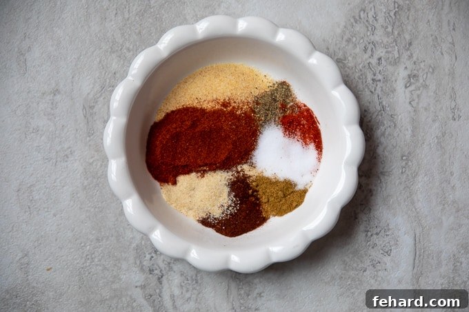 Fajita Seasoning Blend A small white bowl filled with various spices used in fajita seasoning, arranged neatly.