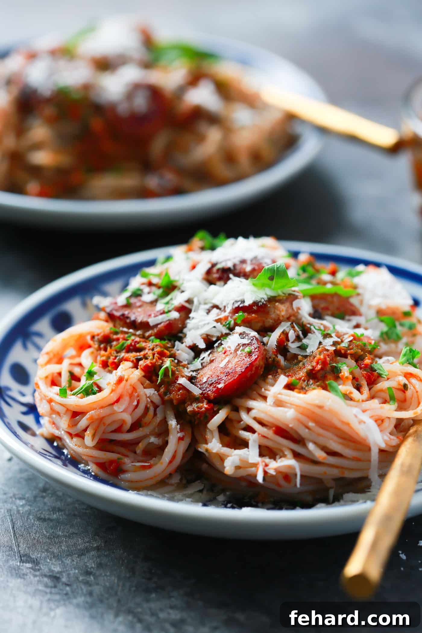 Garnished Italian Sausage Sun-dried Tomato Pesto Pasta A vibrant bowl of Italian Sausage Sun-dried Tomato Pesto Pasta, ready to be served. The rich colors of the pesto and sausage are appealing, suggesting a delightful and healthy meal.