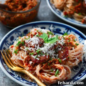 Robust Italian Sausage and Sun-Dried Tomato Pesto Pasta 2 A top-down view of a serving of Italian Sausage Sun-dried Tomato Pesto Pasta, showcasing the vibrant colors and hearty ingredients, presented beautifully for a healthy and satisfying meal.