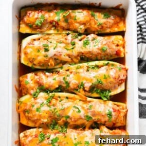 overhead view of zucchini boats in a white casserole