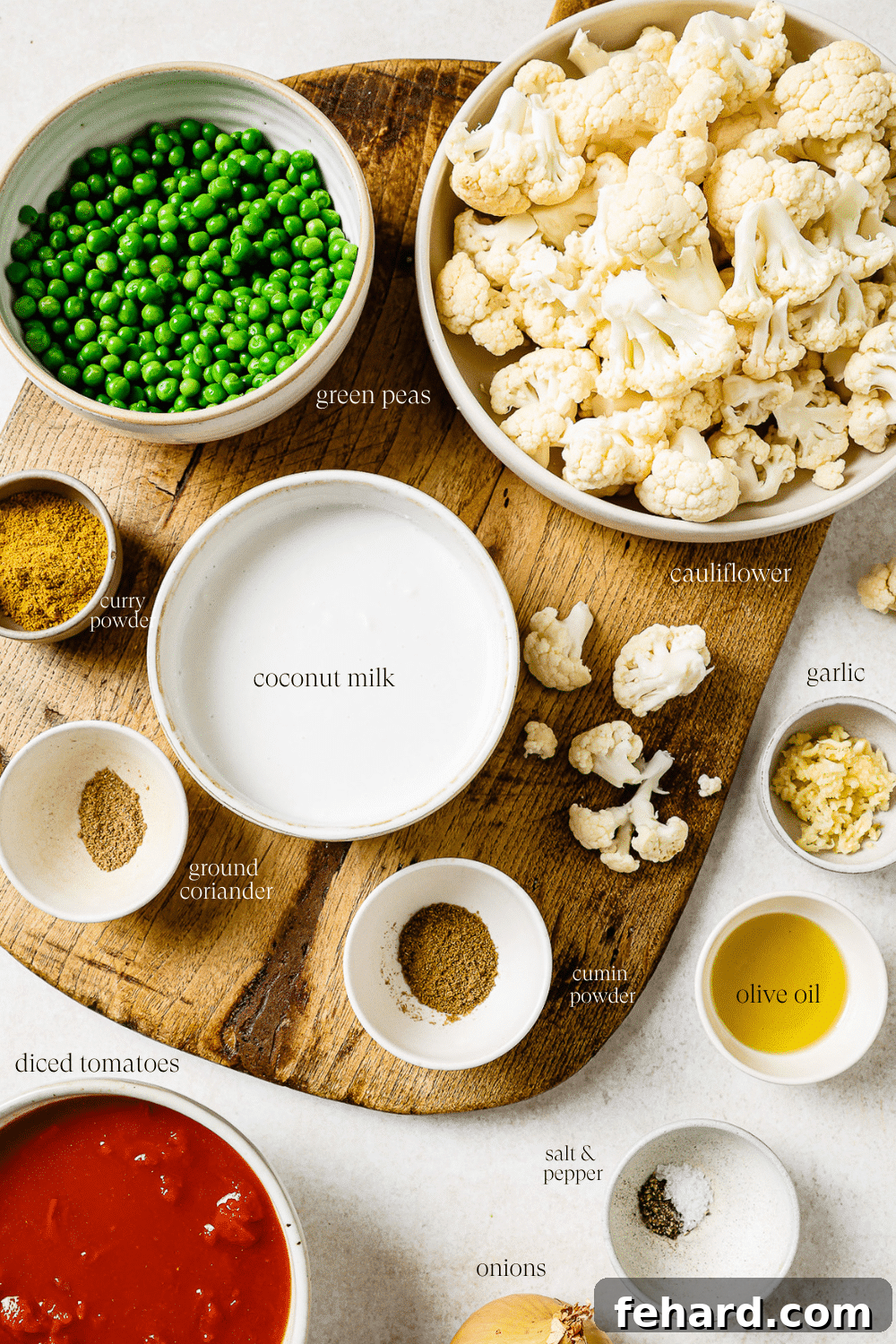 Pre-measured ingredients in small bowls on a wooden cutting board.