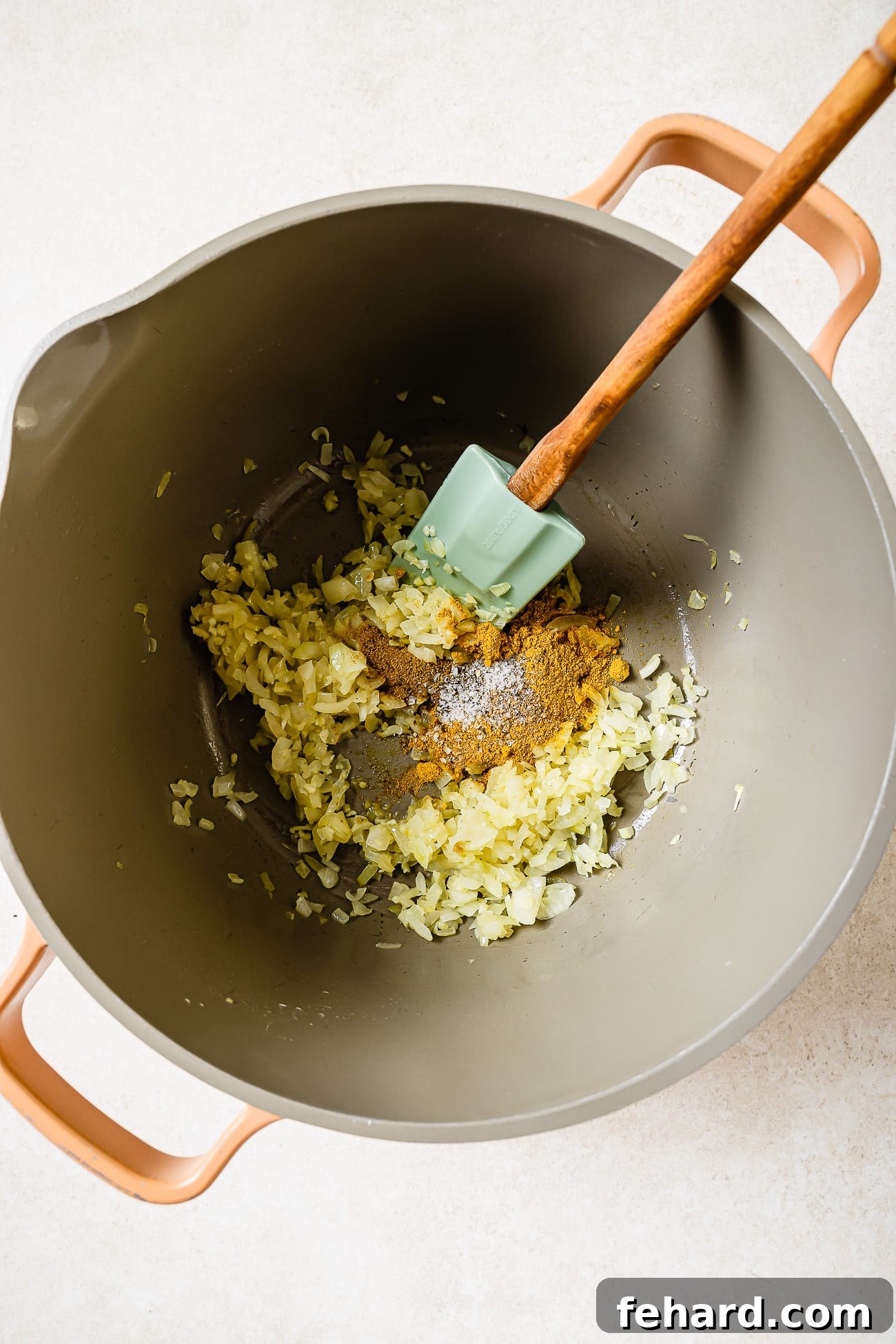 Onions, garlic, and spices in a large Dutch oven.