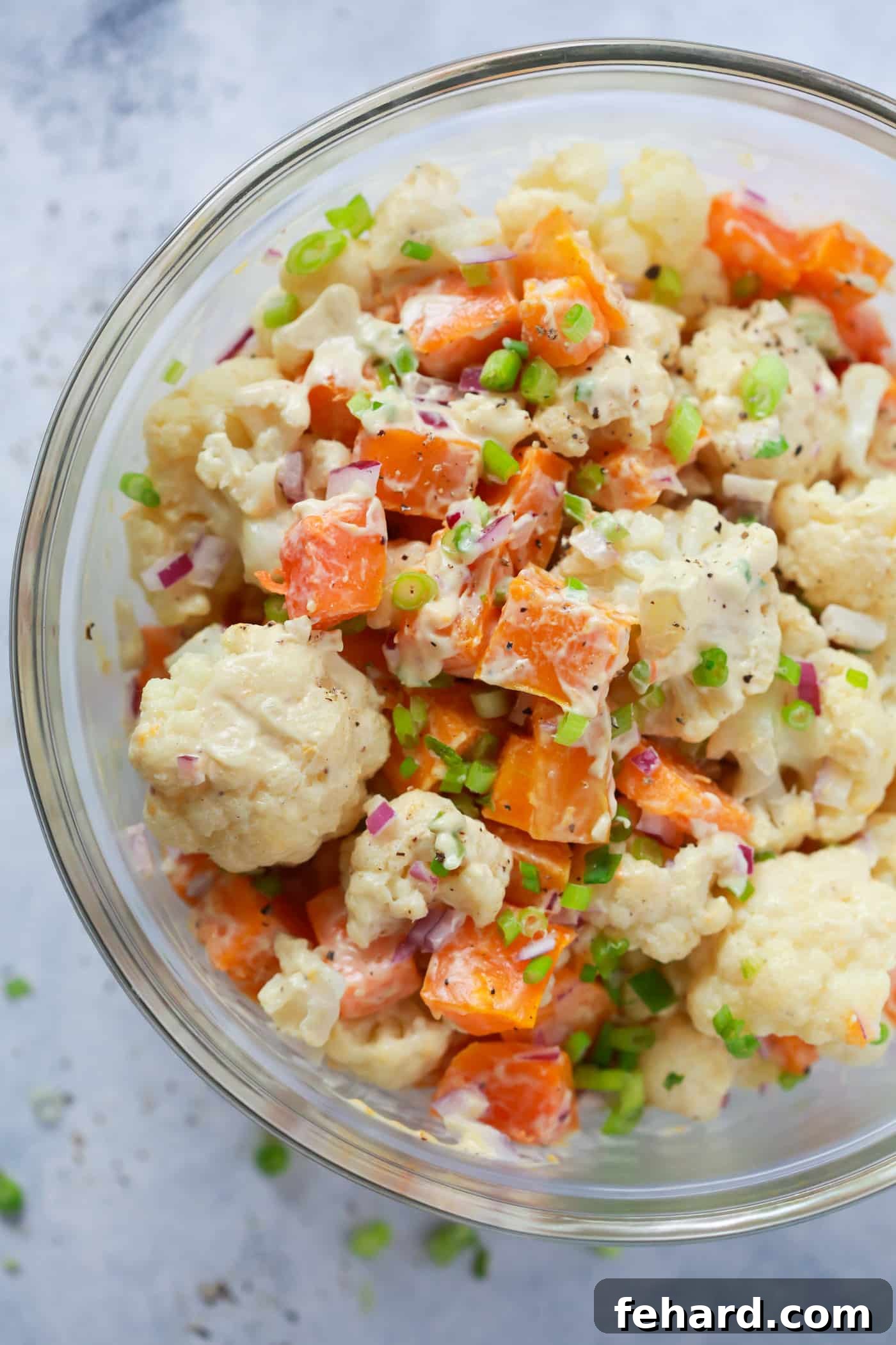 A vibrant Roasted Butternut Squash Cauliflower Salad with a creamy dressing, perfect for fall.