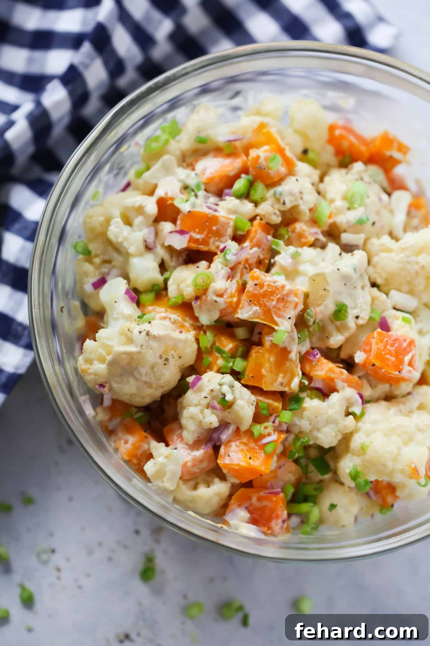A prepared bowl of Roasted Butternut Squash Cauliflower Salad, ready to serve.