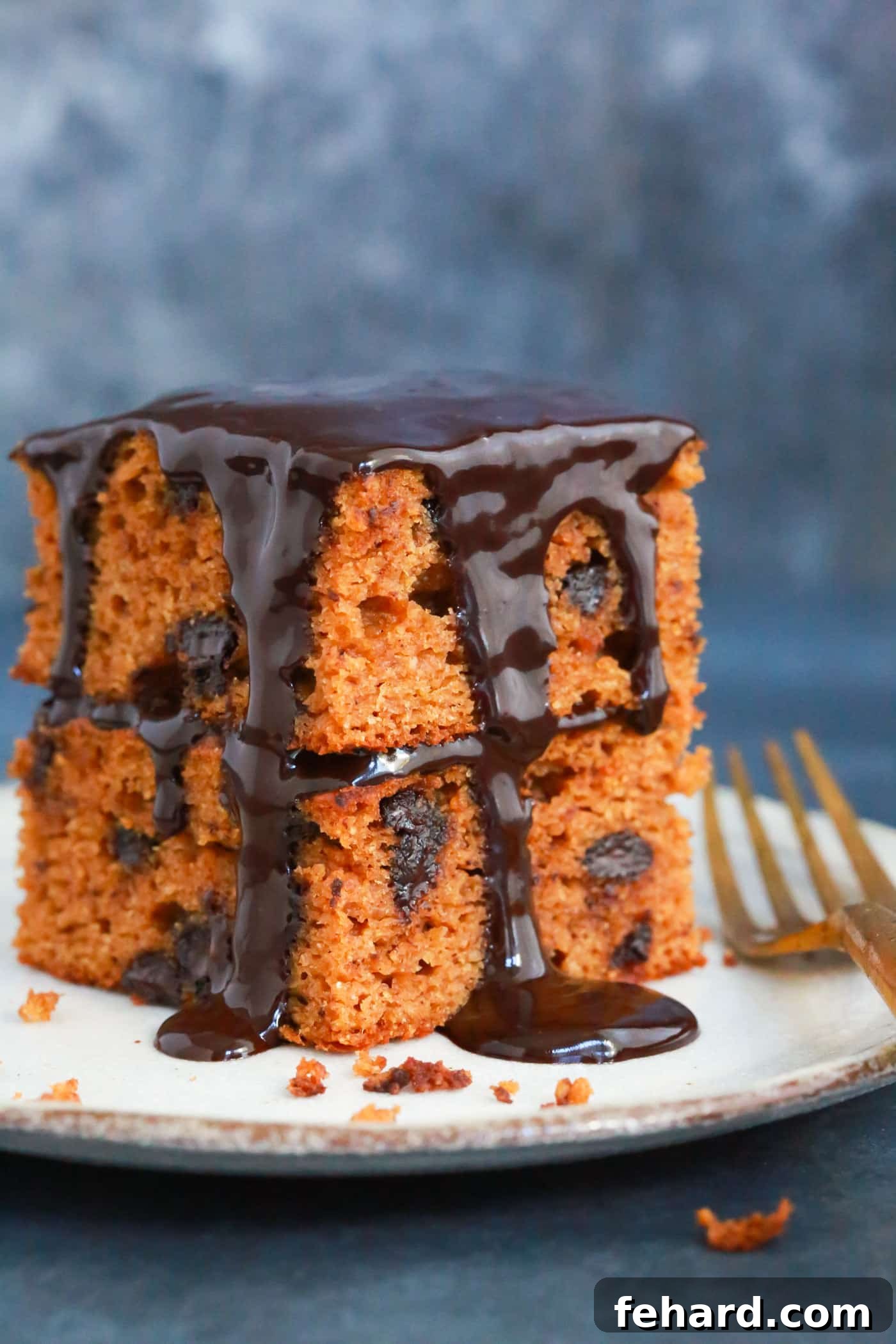 Decadent slice of gluten-free chocolate pumpkin cake with frosting, showcasing its moist texture.